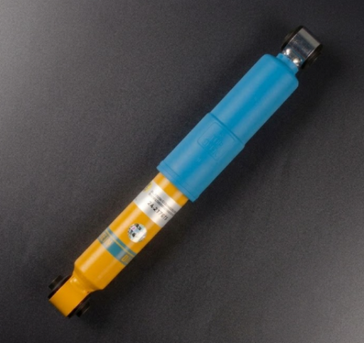 Blue and yellow shock absorber on a black background